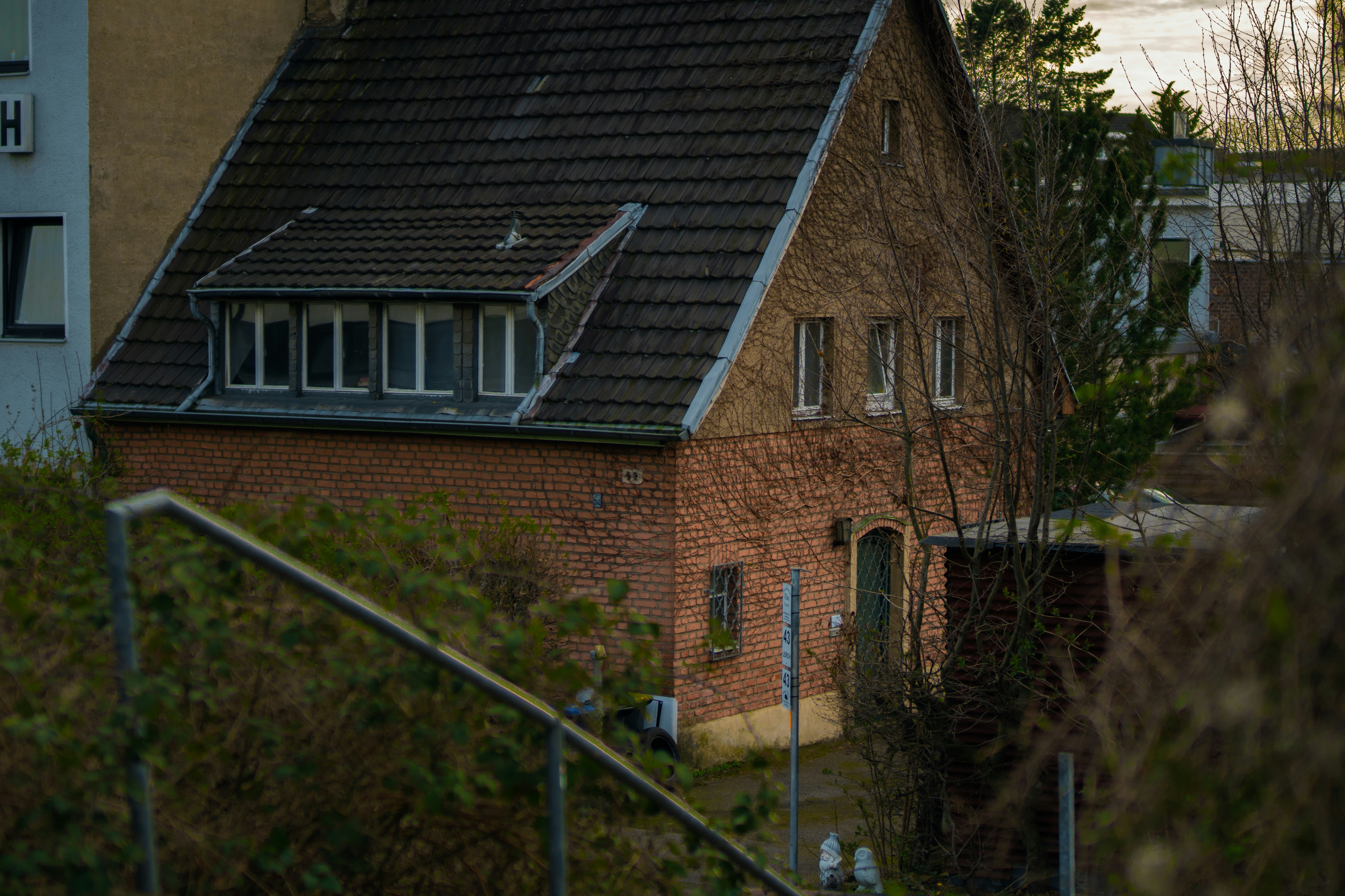 a red brick house with a black roof